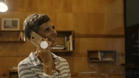 Woman holding gold smartphone to ear, initiating animated data nodes encircling head for tech call. Futuristic, connectivity, digital, interface, networking, data, innovation - Powered by Shutterstock - Get 15% off with code: PIKWIZARD15