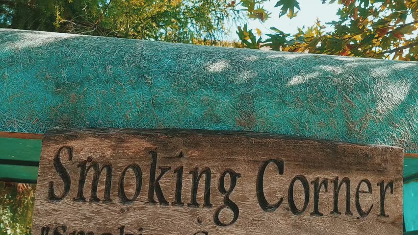 Rustic Wooden Smoking Corner Sign Displayed Outdoors Under Bright Light