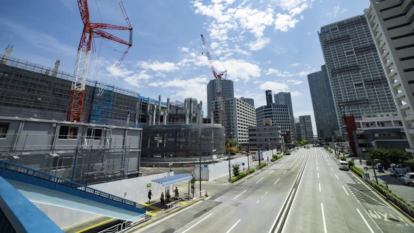 A timelapse of the crane at the under construction in Tokyo wide shot tilt