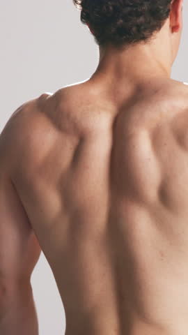 Athlete, man and flex back in studio for fitness, muscle growth and check progress with power. Shirtless, male person and body strength from exercise, bodybuilder transformation and white background