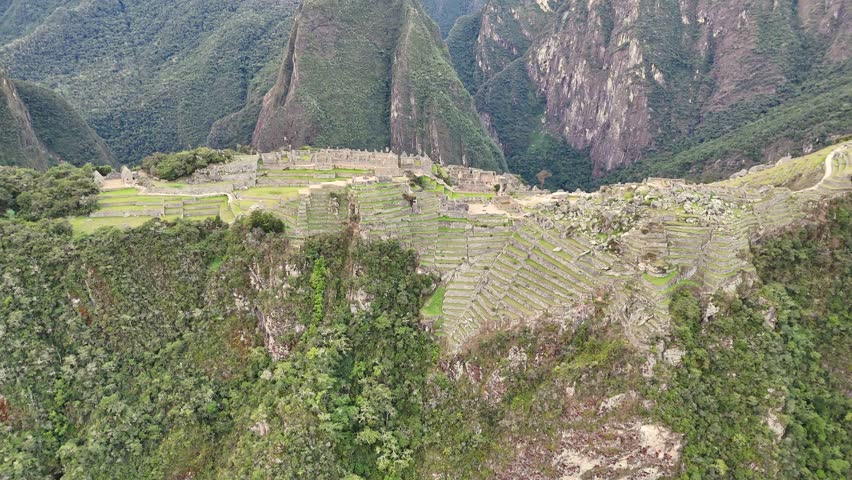 A cinematic shot from mountainside, pans down for a close-up of the intricate Main Temple, continues seamlessly over the Royal Palace and the Prisoner