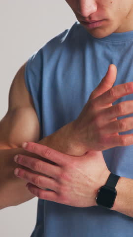 Wrist pain, fitness and man in studio massage for exercise injury, mistake and workout accident. Sports risk, white background and person with inflammation, muscle strain and carpal tunnel for health