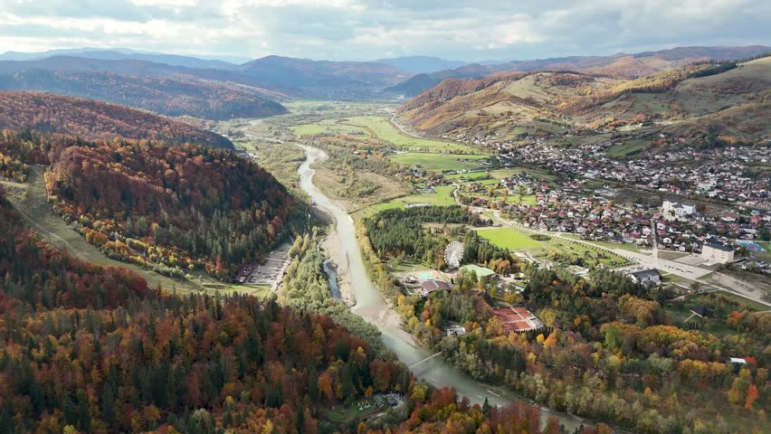 Drone footage showing Ariniș Park and Moldova River valley in Gura Humorului, surrounded by autumn hills