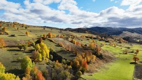 Aerial footage showing fall colors and green fields across rural hills in northern Romania - Powered by Shutterstock - Get 15% off with code: PIKWIZARD15