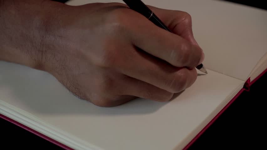 Close-up of Hand Writing on Blank White Paper Notebook with Pen