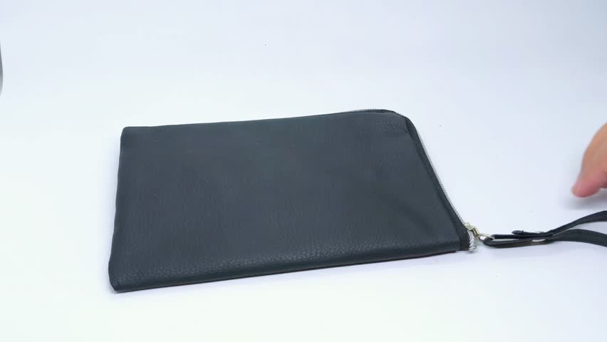 Hands demonstrate a black faux leather pouch, opening and closing the zipper, showcasing its interior, and attaching a wrist strap on a white surface
