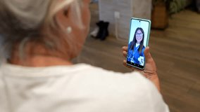Senior woman having an online medical consultation with her doctor via smartphone, receiving professional healthcare advice and support remotely from the comfort of her home - Powered by Shutterstock - Get 15% off with code: PIKWIZARD15