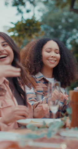 Women, friends and laughing at backyard picnic with food, drinks and bonding at weekend celebration. Happy, holiday and people at table together for bbq, reunion and relax at outdoor social gathering