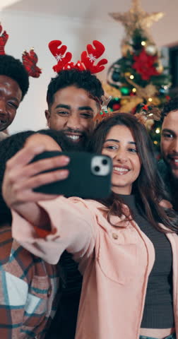 Happy people, christmas and friends with selfie for photography, picture or festive memory in home. Group, community or celebration with smile or peace sign for december holiday or gathering in house