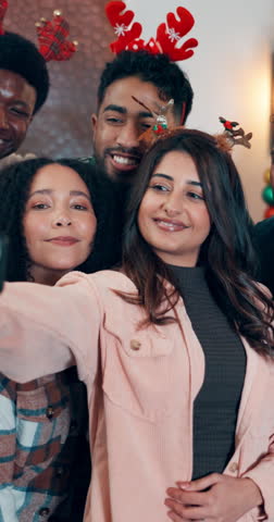 Happy people, christmas and friends with selfie for festive memory, photography or picture in home. Group, community or celebration with smile or peace sign for december holiday or gathering in house