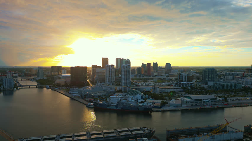 Twilight descends over downtown Tampa from a high up aerial view captures the sun