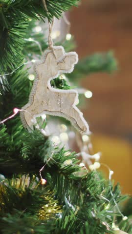 Christmas decorations with reindeer ornament over bokeh lights animation on tree. holiday, festive, celebration