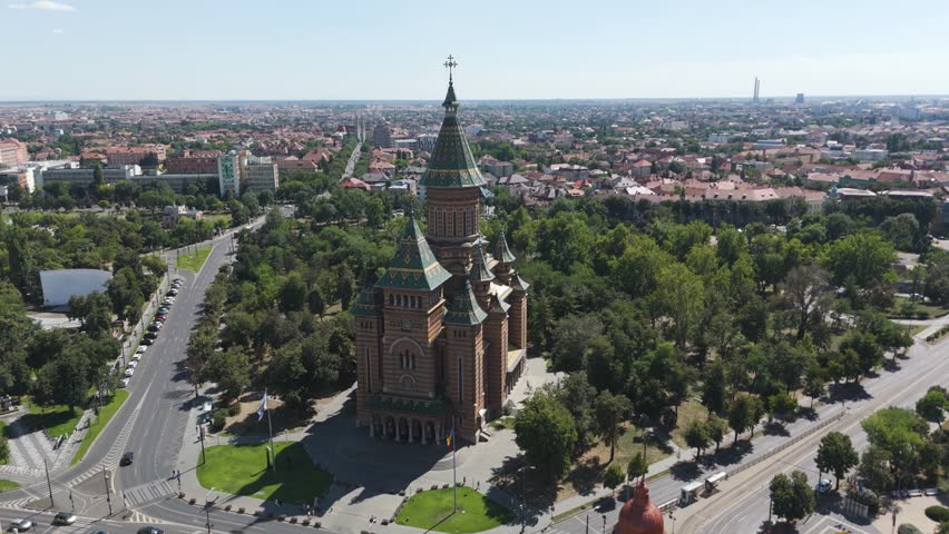 Scenic drone orbit of Timisoara’s Metropolitan Cathedral, showcasing facade details and landmark features.