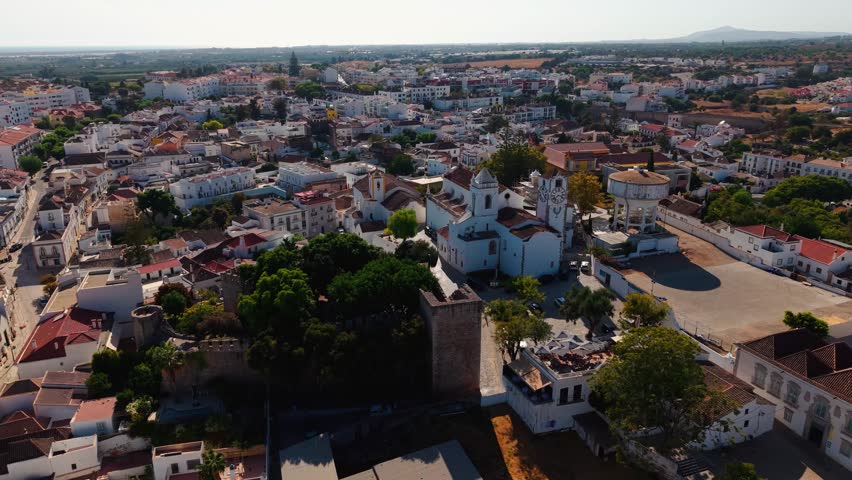 aerial shot over Tavira revealing the Castle and Saint Mary