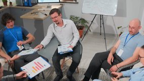 group reviewing colorful data visuals with ongoing discussion and analysis in meeting, team actively examining diverse data charts and reports during office collaborative meeting to exchange insights - Powered by Shutterstock - Get 15% off with code: PIKWIZARD15