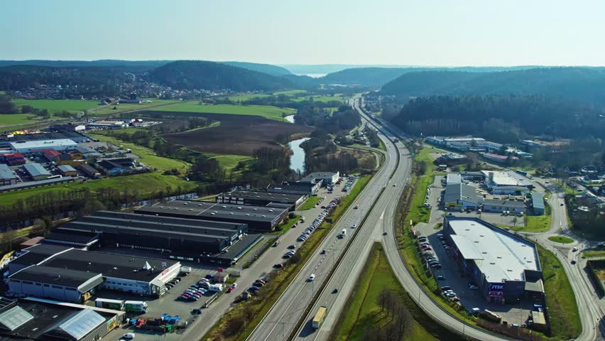 E20 highway leading out from Gothenburg area, Sweden under clear skies