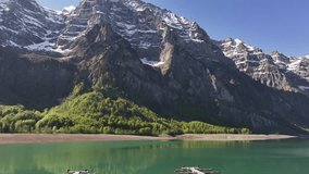 Peaceful Klöntalersee with Vorderglärnisch mountain reflected in turquoise water in Glarus Switzerland - Powered by Shutterstock - Get 15% off with code: PIKWIZARD15