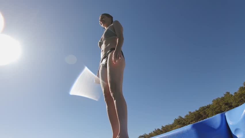 Underwater scene. A young woman dives and swims in the depths of the blue sea