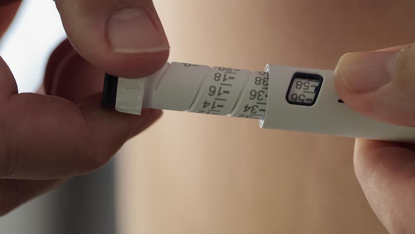 Turning dosage knob on injection pen to dial in proper medication dose