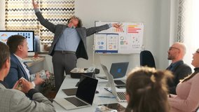 Businessman in suit opens suitcase full of dollar bills during office meeting, handing out cash to colleagues as a bribe, symbolizing corruption, illegal finance and shady deal. - Powered by Shutterstock - Get 15% off with code: PIKWIZARD15