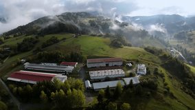 Farm in misty countryside, Rural farm complex nestled among misty hills - Powered by Shutterstock - Get 15% off with code: PIKWIZARD15