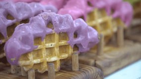 waffle cookie . Waffles with colorful icing . Delicious stack of waffles with colourfull syrup. Unique waffles with colorful icing from a local bakery in a busy city market. - Powered by Shutterstock - Get 15% off with code: PIKWIZARD15