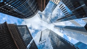 Rotating motion time lapse view of looking directly up at the skyline of the financial district in London with clouds passing by, background for modern architecture - Powered by Shutterstock - Get 15% off with code: PIKWIZARD15