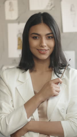 fashion designer woman in white jacket holding glasses looking confident inspired representing elegance success realization creative spirit vertical slow motion fullhd stock video