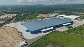 Cervecería Nacional Dominicana, brewery logistics hub, modern warehouse and industrial complex in Hato Nuevo, Santo Domingo Oeste, rural landscape, Dominican Republic. Aerial drone - Powered by Shutterstock - Get 15% off with code: PIKWIZARD15