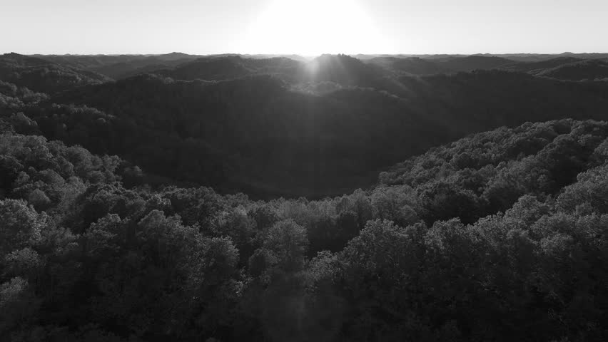 Aerial view over the Appalachian Mountains of eastern Kentucky in October with beautiful fall colors. Clip transitions from black and white to vibrant color.