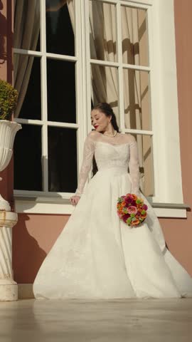 Beautiful happy brunette bride in white dress