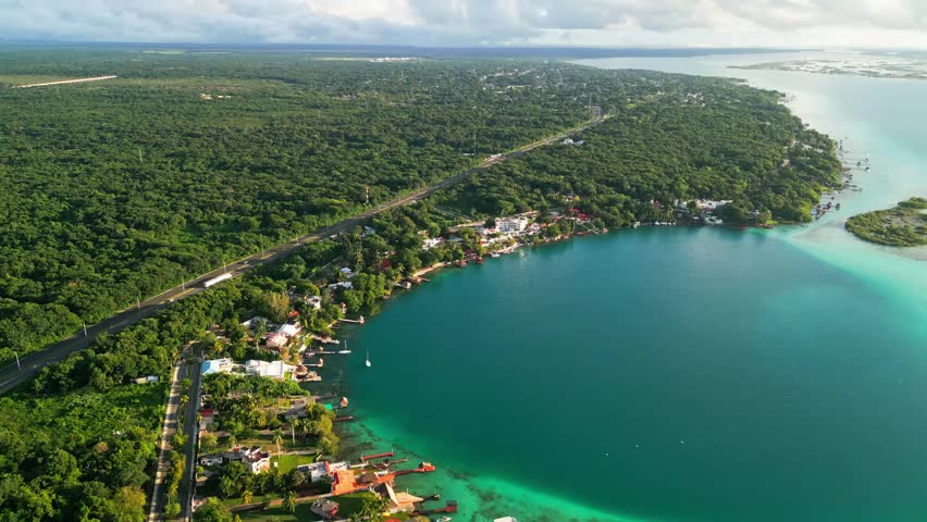 Lakeside Hotels And Tropical Dense Forest On The Lagoon In Bacalar, Quintana Roo, Mexico. Aerial Pullback Shot