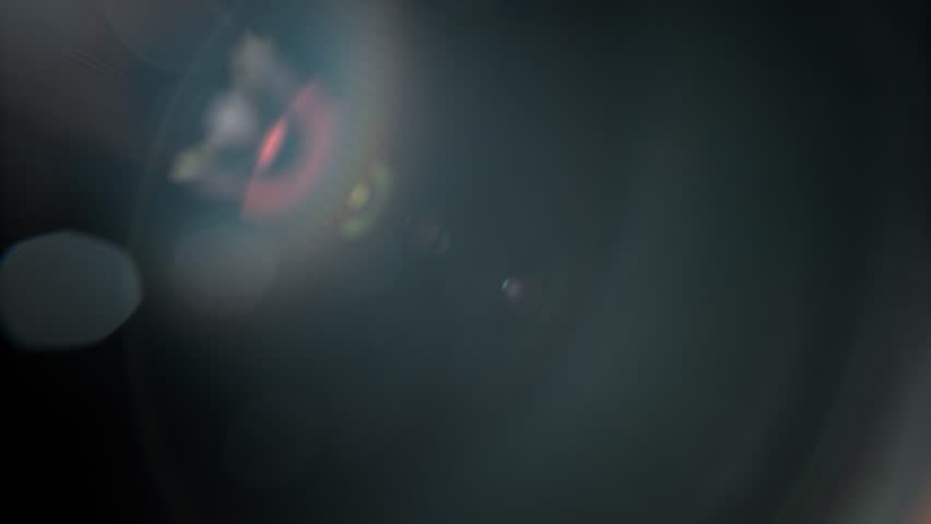 Slow motion of real lens flare through glass effects for overlay or transition