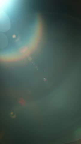 Slow motion of real lens flare through glass effects for overlay or transition