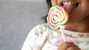 Girl Eating a Colorful Lollipop 4k - Powered by Shutterstock - Get 15% off with code: PIKWIZARD15