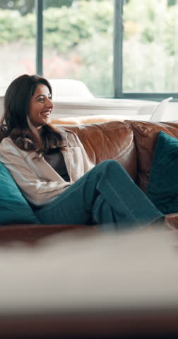 Happy couple, watching tv and hug on couch together, pointing and laughing at funny movie scene. Bonding, streaming film or woman with man chill in home, subscription platform and support on weekend