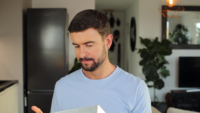 Cheerful man holding a "HAPPY" sign 