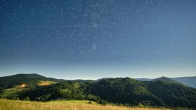 Star trails over moonlit mountain meadow at night, timelapse - Powered by Shutterstock - Get 15% off with code: PIKWIZARD15
