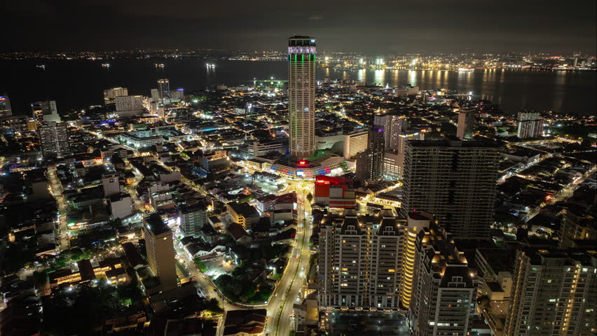 night time illumination penang island george town famous city center tower aerial panorama 4k timelapse malaysia