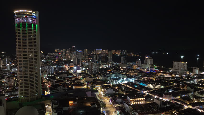 night time illumination penang island george town city center famous tower traffic streets aerial panorama 4k timelapse malaysia