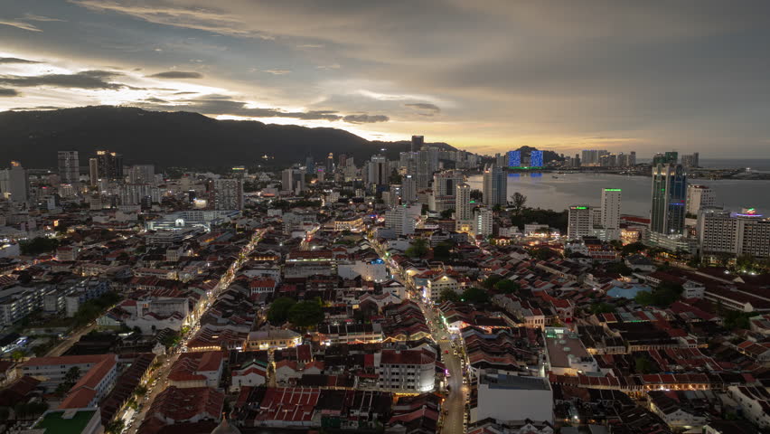 sunset sky night time illumination penang island george town cityscape aerial panorama 4k timelapse malaysia