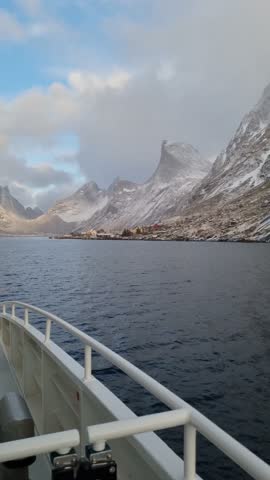 Fishing boat in the fjord. Aerial view of Lofoten Islands, Norway. Industrial fishing. View from a drone. Aerial landscape. Mountains and water. Image of Norway
