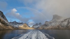 Beautiful snowy mountains over fishing village Reine in Lofoten islands, Norway, with partially frozen fjord and rainbow in winter at sunrise. Dramatic sky over snowy rocks and sea at dawn
 - Powered by Shutterstock - Get 15% off with code: PIKWIZARD15