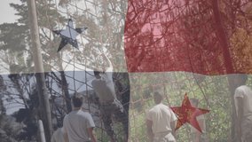 Military trainee responding to voice cue climbing red cargo net training with national flag overlay. Adventure, teamspirit, resilience, outdoor, rugged, discipline, athletic - Powered by Shutterstock - Get 15% off with code: PIKWIZARD15