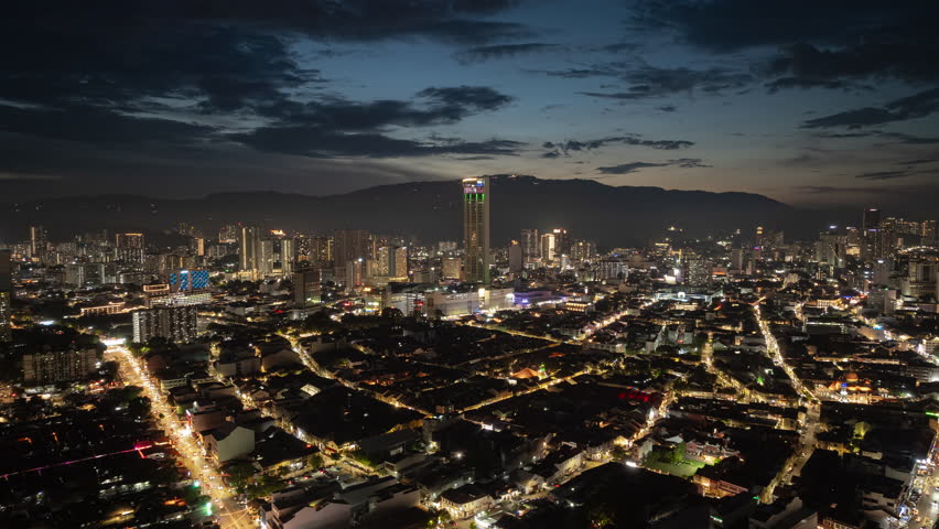 sunset sky night time illumination penang island george town traffic streets central cityscape aerial panorama 4k timelapse malaysia