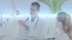 Doctor holding spine model and pointing vertebrae explaining anatomy, digital overlays emerging. Medical, healthcare, technology, diagnostics, education, visualization, professional - Powered by Shutterstock - Get 15% off with code: PIKWIZARD15