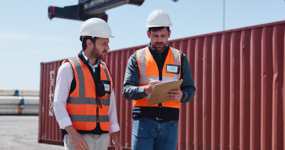 People, reading and clipboard at shipping yard for inspection, distribution and track cargo. Men, teamwork and checklist for logistics shipment, inventory and supply chain of freight at industry port
