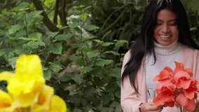 Young smiling woman holding a beautiful bouquet of fresh orange flowers. She is enjoying a peaceful day in a lush green garden setting - Powered by Shutterstock - Get 15% off with code: PIKWIZARD15