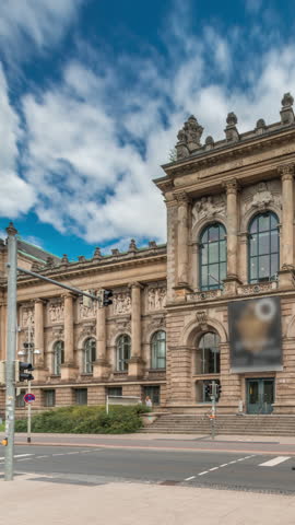 Hyperlapse of Hanover's Lower Saxony State Museum with passing traffic and people in front of its historic facade. Cloudy sky frames cultural landmark in the heart of Germany s Niedersachsen timelapse