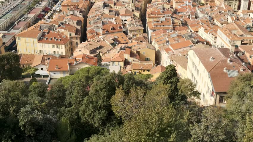 Discover the stunning red rooftops and narrow streets of Nice's historic Old Town from above. A breathtaking aerial view of the French Riviera's architectural charm.